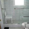 Marble Tile Shower with ADA Faucet & Toilet