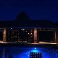 Pool House with Recessed Soffit Lights at Night