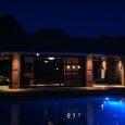 Finished Pool House with Recessed Soffit Lights at Night